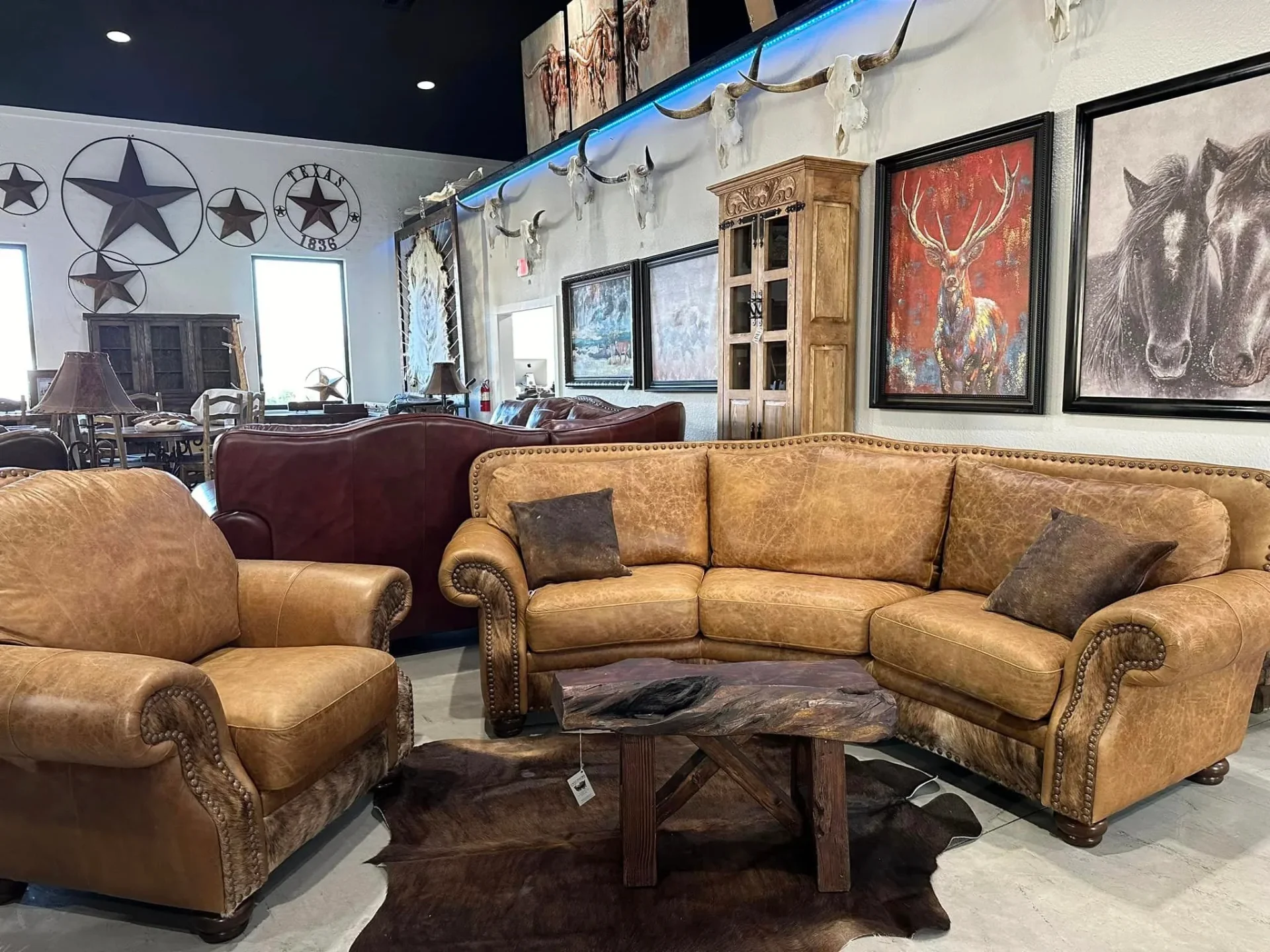 Casa Decor Weatherford showroom – saddle leather sectional, longhorn skulls, and original western art